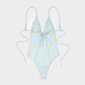 Costume da bagno azzurro con stampa soli gialli